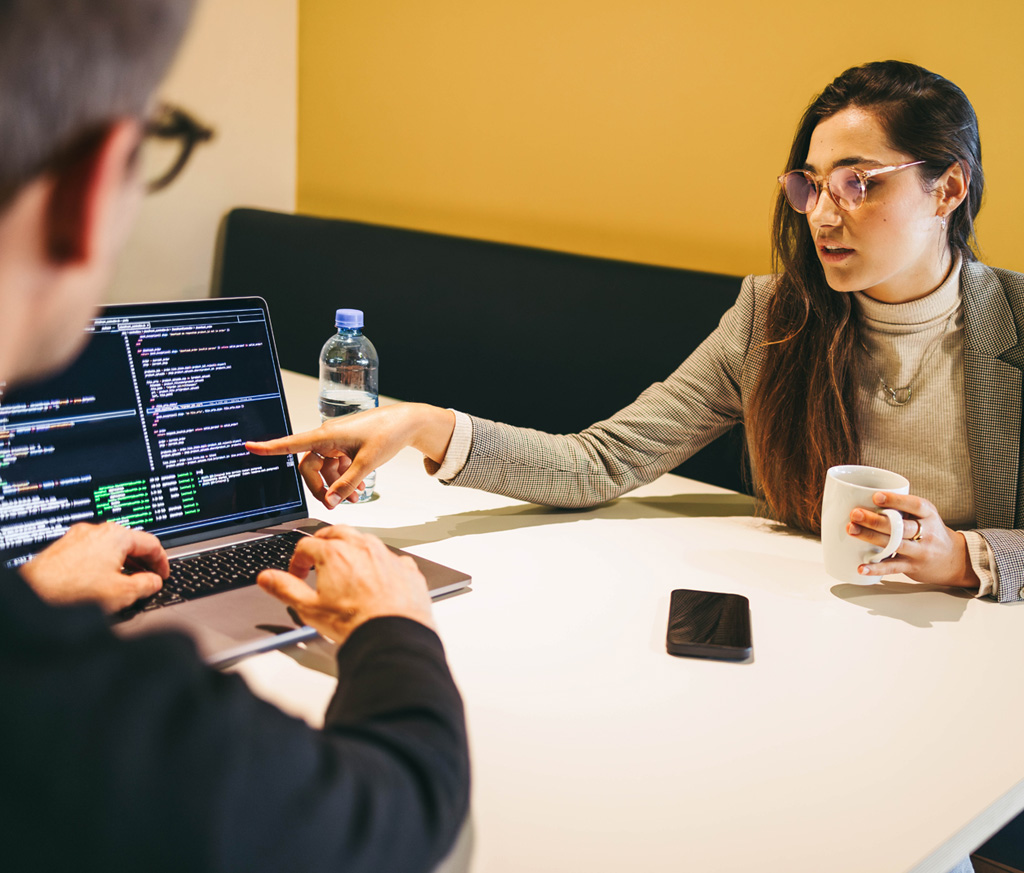 Women Showing Employee Data on Laptop